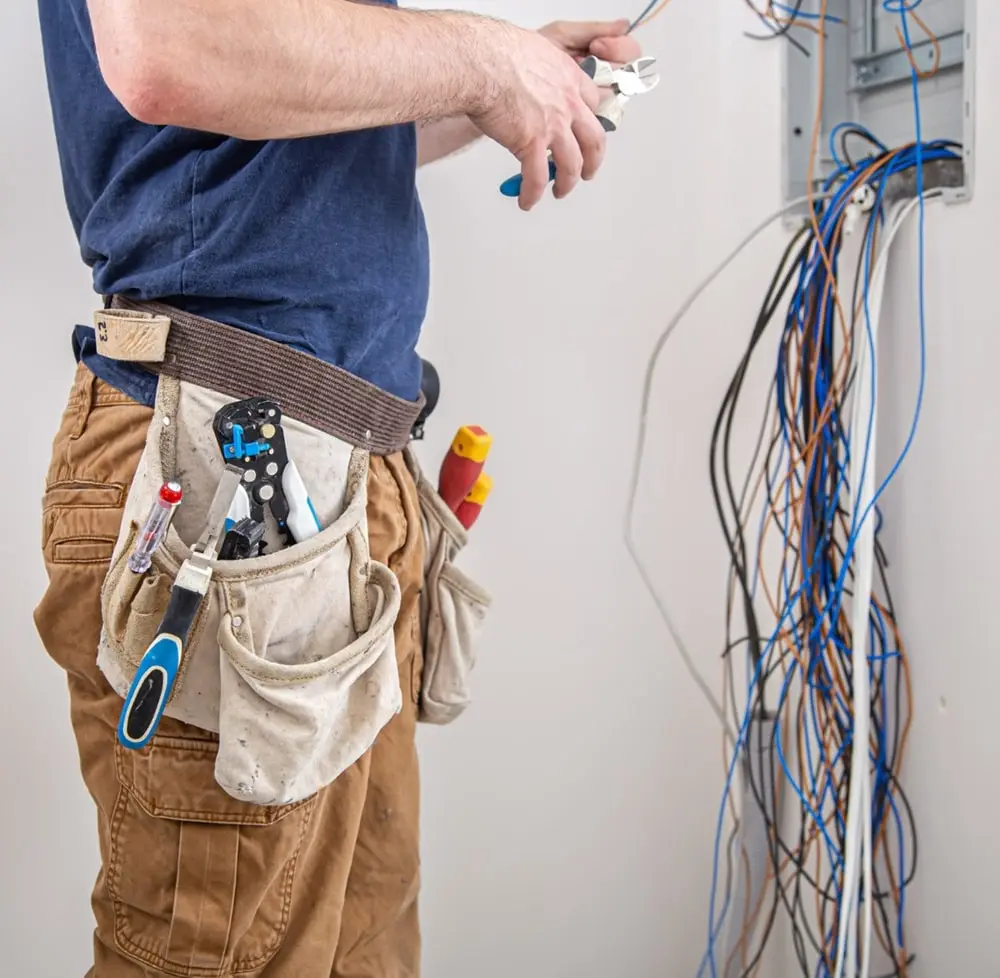 24 hour emergency electrician from Universal Electrical Service fixing a switchboard during an emergency electrical service.